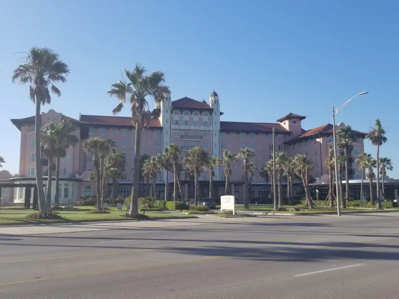 A neat fancy pink Spanish style hotel near the ocean from the early-mid 1900's