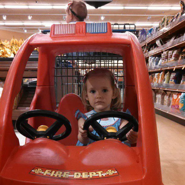 Nora finds car carts at grocery store.