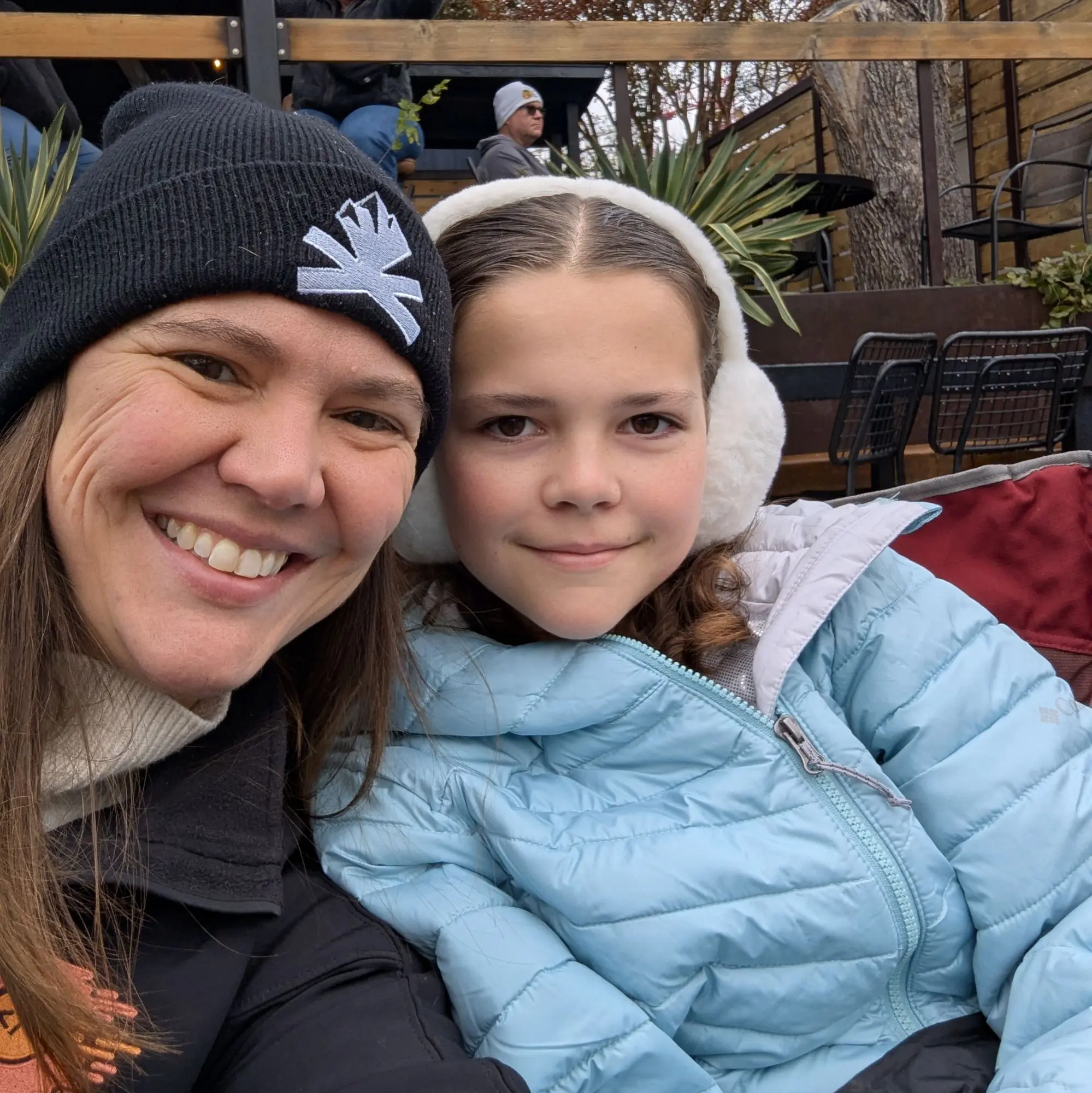 Amber and Zara take a selfie. Amber is wearing a WordCamp Denver stocking cap.