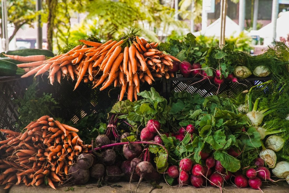piles of carrots, beets, and raddishes